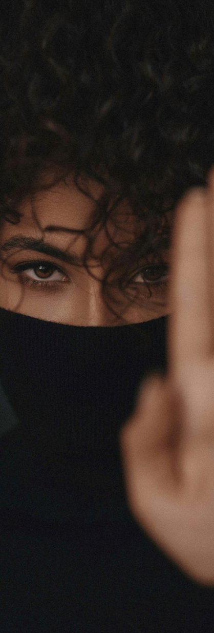 woman covering her face with her hair